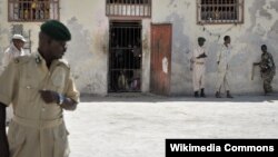 FILE - Prison guards stand outside a cell in Mogadishu Central Prison, December 10, 2013.