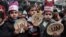 Palestinian children hold bread patties during a protest against aid cuts, outside the United Nations' offices in Khan Yunis in the southern Gaza Strip on Jan. 28, 2018.