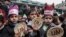 Palestinian children hold bread patties during a protest against aid cuts, outside the United Nations' offices in Khan Yunis in the southern Gaza Strip on January 28, 2018.