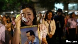 A woman weeps after an announcement that Thailand's King Bhumibol Adulyadej has died, at the Siriraj hospital in Bangkok, Thailand, Oct. 13, 2016.