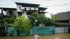 A man wades through his flooded neighborhood in Colombo, Sri Lanka, Monday, Oct. 14, 2024. 