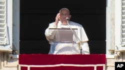 Pope Francis appears at his studio's window overlooking St. Peter's Square at The Vatican to bless pilgrims and faithful after presiding over a mass in St. Peter's Basilica on New Year's Day, Jan. 1, 2025. 