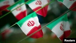 FILE - Iran's national flags fly in a square in Tehran, Feb. 10, 2012, a day before the anniversary of the Islamic Revolution. 