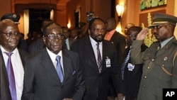 Zimbabwean President Robert Mugabe (2nd L) arrives at the SADC (Southern African Development Community) troika summit in Livingstone, Zambia, March 31, 2011