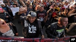 Protesters from an anarchist group shout slogans as they march against fuel price hikes in Mexico City, Jan. 9, 2017. 