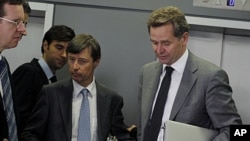 European Commission official Matthias Mors, center, and International Monetary Fund's Paul Thomsen, right, walk after their meeting with Greek Finance Minister Evangelos Venizelos, in central Athens, Sept. 30, 2011.