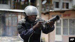 Riot policeman aims a tear gas gun in Democratic Republic of Congo's capital Kinshasa, Dec. 10, 2011.