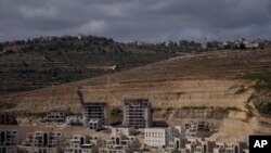 FILE - This photo shows a construction site of new housing projects in the West Bank Israeli settlement of Givat Ze'ev, June 18, 2023. The population of settlers in the occupied West Bank grew nearly 3% in 2023, according to a report from the Israeli government.