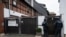 Police officers are standing in front of an apartment building in Erfurt, Germany, Jan. 23, 2020. Germany's top security official has announced a ban on the neo-Nazi group 'Combat 18' Deutschland. 