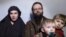 A still image from a video posted by the Taliban on social media, Dec. 19, 2016, shows American Caitlan Coleman speaking next to her Canadian husband, Joshua Boyle, and their two sons. 