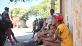 TOPSHOT - Families take to the streets to escape the gangs in Solino, a neighborhood of Port-au-Prince, Haiti, January 18, 2024.