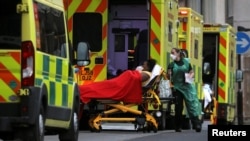 Medical workers transport a patient from an ambulance at the Royal London Hospital amidst the spread of the coronavirus disease (COVID-19) pandemic, in London, Britain, Jan. 10, 2021. 