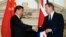 FILE - British Prime Minister David Cameron, right, shakes hands with China's President Xi Jinping, at the UK-China Business Summit in Mansion House, central London, Oct. 21, 2015