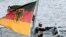 FILE - A gunner stands in position aboard a German Navy frigate during exercises in the Baltic Sea, near Rostock, Germany, Sept. 11, 2019.
