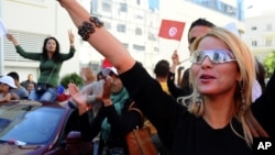 Supporters of Tunisian party Nida Tunis (Tunisia Calls) celebrate their victory in parliamentary elections in Tunis, Tuesday, Oct.28, 2014. 