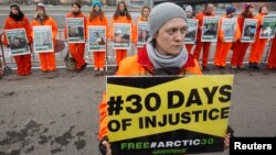 Greenpeace activists hold portraits of those detained on the boat Arctic Sunrise, during a rally in Moscow, Oct. 18, 2013.