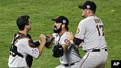 San Francisco Giants Brian Wilson celebrates with Buster Posey, left and Aubrey Huff, right after winning the World Series in Game 5 of baseball's World Series against the Texas Rangers, in Arlington, Texas. The Giants won 3-1 to capture the series, 1 Nov