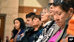 FILE - Elders from the Northern Cheyenne Tribe in Montana listen to speakers during a session for survivors of government-sponsored Native American boarding schools, in Bozeman, Montana, Nov. 5, 2023.