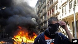 Demonstrator covers face during general strike in Barcelona, Spain, March 29, 2012.