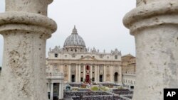 FILE - Faithful gather to follow Pope Francis celebrating Easter Mass in St. Peter's Square at the Vatican, Apr. 21, 2019.