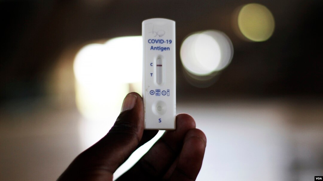 A man holds a Covid-19 testing kit at a private health facility in Harare, Zimbabwe, Thursday, Feb, 3, 2022. African nations have very limited access to COVID-19 tests, especially at-home tests. (AP)