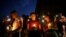 Samuel Lerma, Arzetta Hodges and Desiree Qunitana join mourners at a vigil at El Paso High School after a mass shooting at a Walmart store in El Paso, Texas, Aug. 3, 2019.