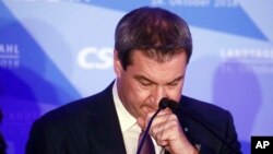 Bavarian governor Markus Soeder reacts during his first appearance after the first exit polls for the Bavarian state election in Munich, southern Germany, Sunday, Oct. 14, 2018. 