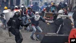 FILE - Demonstrators clash with police during an anti-government protest in Cali, Colombia, July 20, 2021, as the county marks its Independence Day. 