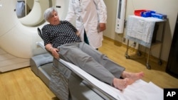 Judith Chase Gilbert, of Arlington, Va., is loaded into PET scan machine by Nuclear Medicine Technologist J.R. Aguilar as part of a study on Allheimer's disease at Georgetown University Hospital, on Tuesday, May 19, 2015.