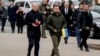 Ukraine's President Volodymyr Zelenskyy, right, and German Chancellor Olaf Scholz walk to a memorial honoring fallen soldiers, in Kyiv, Ukraine, Dec.2, 2024. 