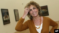 FILE - Portuguese-British artist Paula Rego reacts during an interview next to some of her paintings at the Serralves Museum, Oct. 15, 2004 in Porto, northern Portugal.