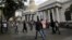 FILE - People walk past the National Assembly building in Caracas, Venezuela, Dec. 22, 2015.