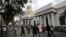 People walk past the National Assembly building in Caracas, Venezuela, Dec. 22, 2015.