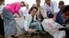 Aung San Suu Kyi Picks up Trash, Literally