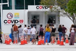 People line up at a COVID-19 rapid test site, Nov. 7, 2020 in Miami Beach, Fla.