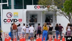 People line up at a COVID-19 rapid test site, Saturday, Nov. 7, 2020 in Miami Beach, Fla. According to an AP analysis of data from John Hopkins University, the 7-day rolling average for daily new cases rose from 61,166 on Oct. 22 to 94,625 on Nov. 5…