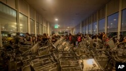 Trolleys block an entrance at El Prat airport, on the outskirts of Barcelona, Spain, Oct. 14, 2019. 