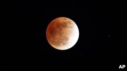 FILE - Lunar eclipse is seen in Shanghai, China.