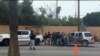 En esta imagen tomada de un video, fuerzas de seguridad mexicanas registran a hombres en un puesto de control, el jueves 2 de mayo de 2024, en Ensenada, México.