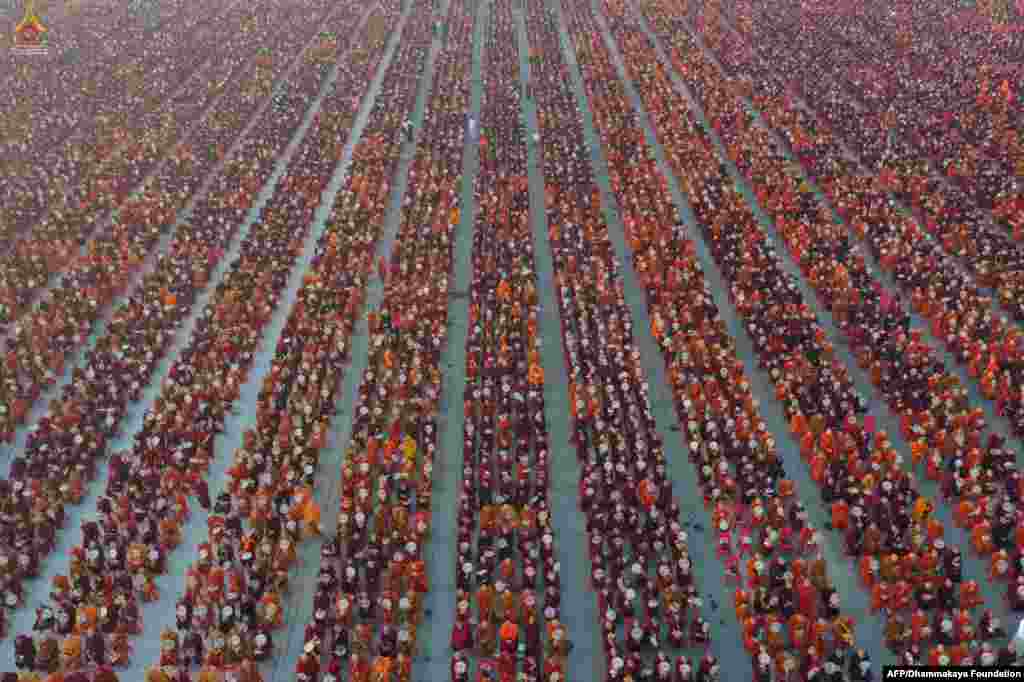 A handout photo released by Dhammakaya Fondation shows monks lining up for alms during the alms-giving ceremony to 30,000 monks at Chanmyatha Airport in Mandalay, Myanmar.