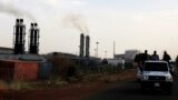 FILE - A vehicle with Sudan People's Liberation Army (SPLA) soldiers travels past the Paloch oil field facility in Paloch, Upper Nile state, South Sudan, March 2, 2014.