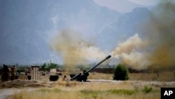 FILE - In this June 1, 2011, file photo, Pakistani troops fire heavy artillery toward alleged militants hideouts in mountain ranges along the Afghan border. 