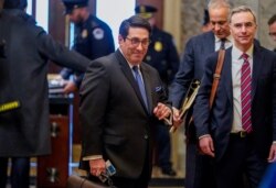 U.S. President Donald Trump's personal attorney Jay Sekulow and White House counsel Pat Cipollone pass through security as they arrive for opening arguments in the impeachment trial of U.S. President Donald Trump at the U.S. Capitol in Washington.