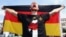 German soccer player Per Mertesacker celebrates on stage at the German team victory ceremony, near the Brandenburg Gate in Berlin, Germany, July 15, 2014. 