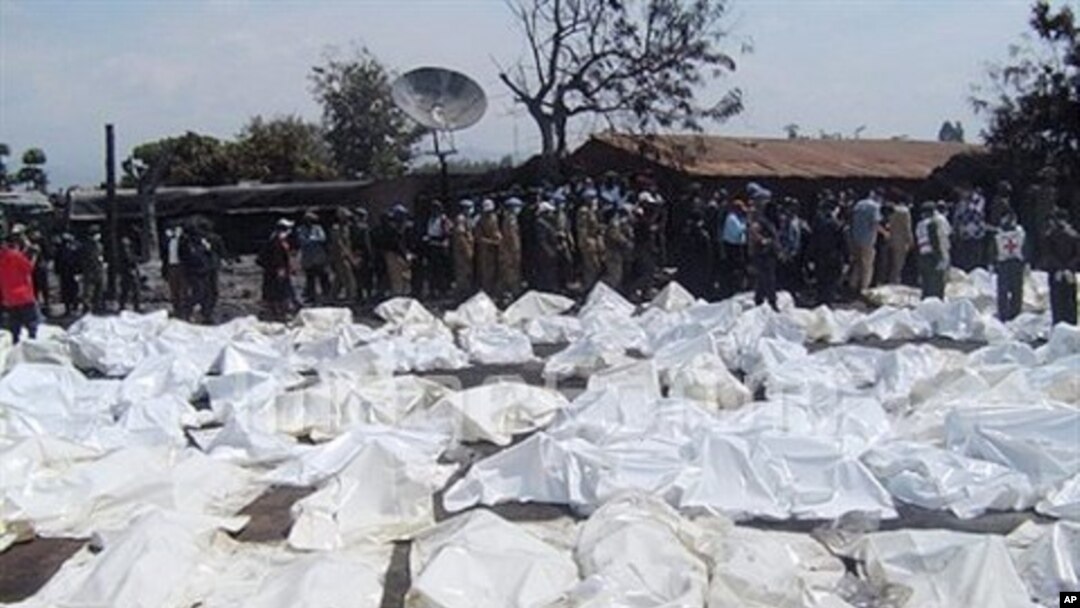UN Peacekeepers and medics stand beside the bagged bodies of victims of an oil tanker explosion in Sange, Democratic Republic of Congo, 03 Jul 2010