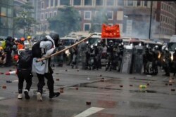 Protesters use bamboo sticks as they face riot police during a protest in Hong Kong, Aug. 25, 2019.