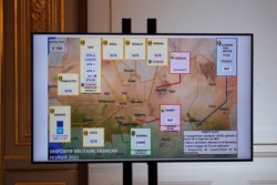 FILE - A map of French army locations in Sahel is seen as French President Emmanuel Macron delivers his speech after a meeting via video-conference with leaders of West African G-5 Sahel nations, in Paris, France, Feb. 16, 2021.