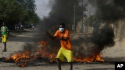 FILE — A man gestures during a protest in N'Djamena, April 27, 2021.