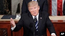 President Donald Trump gestures toward Democrats while addressing a joint session of Congress on Capitol Hill in Washington, Feb. 28, 2017.