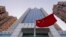 FILE - A Chinese national flag flutters outside China's liaison office building in Hong Kong, Jan. 6, 2020.
